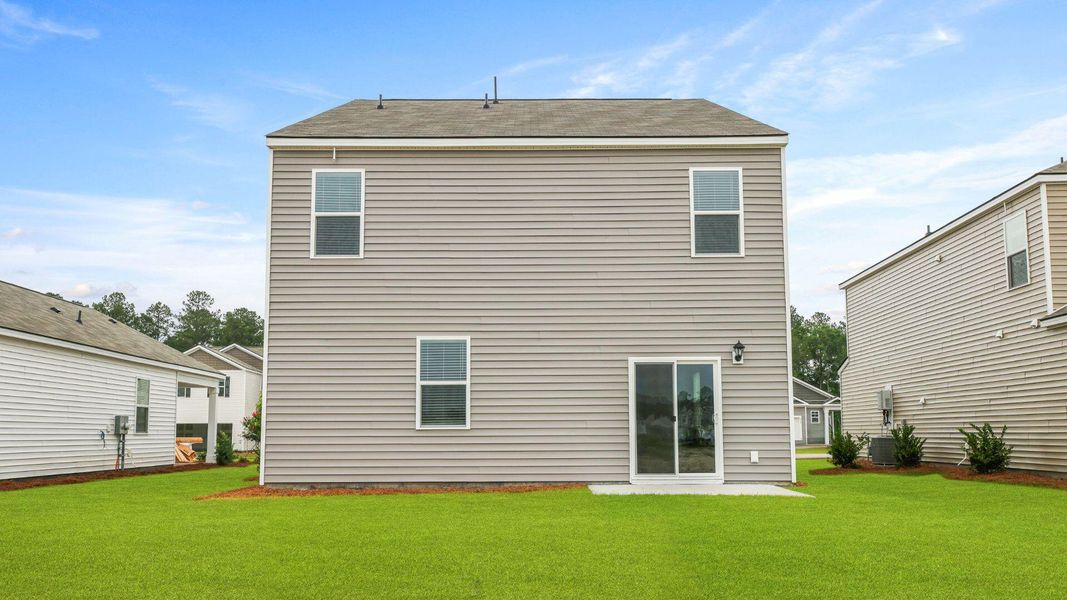 Exterior details and patio area of a home in Pine Hills at Cane Bay, Moncks Corner (Image 20).