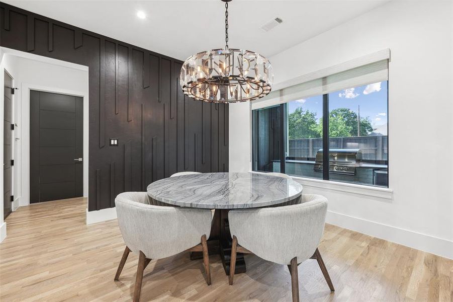 Dining area featuring a notable chandelier and light hardwood / wood-style floors