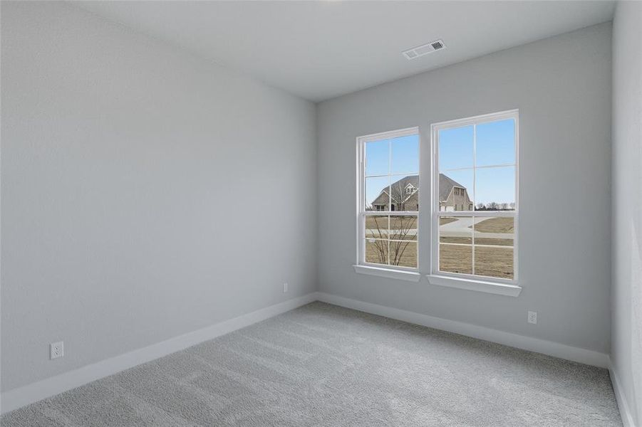 Carpeted empty room featuring baseboards