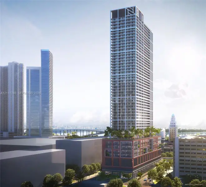 High-rise tower featuring a tiered architectural design, masonry podium facade, grid-patterned glass exterior, and an elevated terrace with landscaping