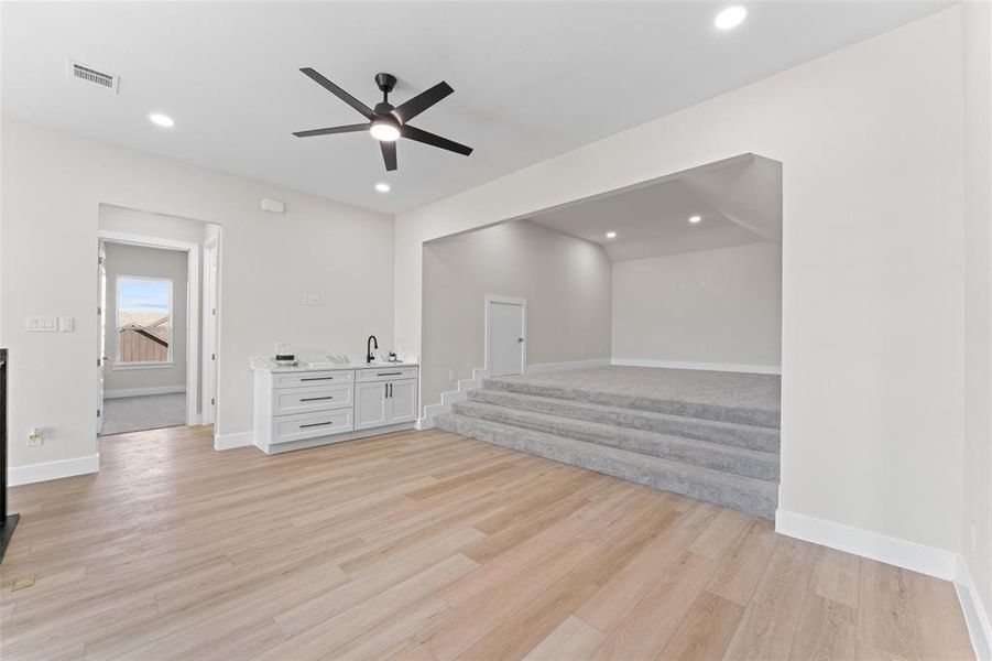 Empty room featuring light wood-style floors, a ceiling fan, and recessed lighting Empty room featuring light wood-style floors, a ceiling fan, and recessed lighting