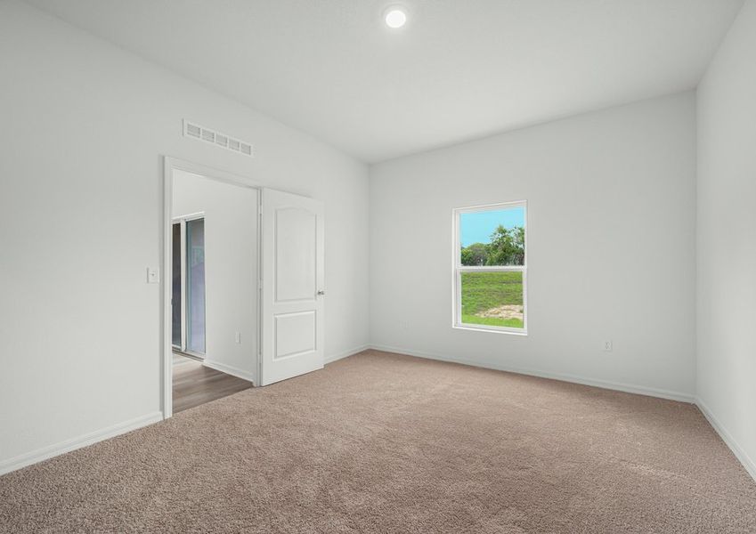 Master bedroom with a view of the back yard
