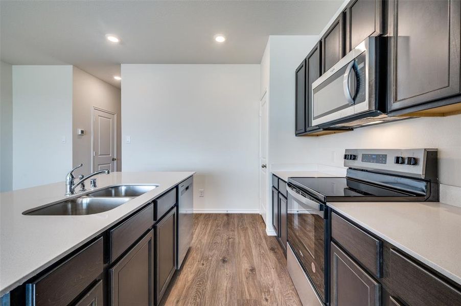 Kitchen with sink, stainless steel appliances, and light hardwood / wood-style flooring