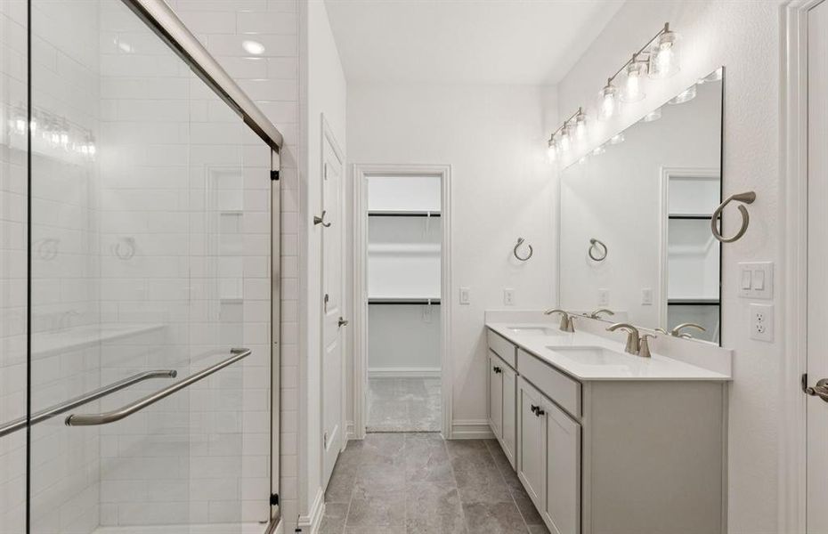 Modern owner's bath with dual vanities and a spacious shower *Real home pictured Modern owner's bath with dual vanities and a spacious shower *Real home pictured