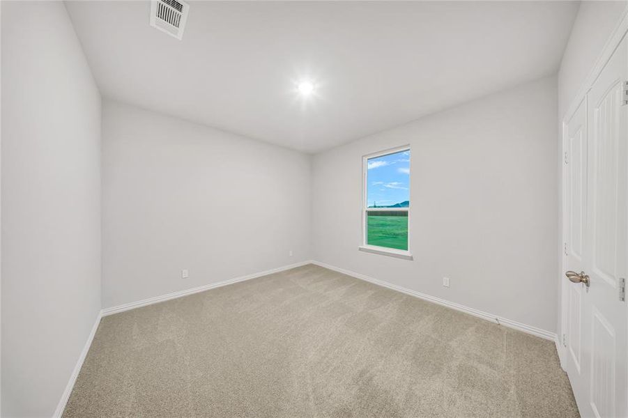Empty room featuring light colored carpet Empty room featuring light colored carpet