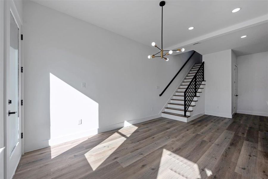 The open floor plan on the main floor has gorgeous light fixtures. There is no carpet in this home.