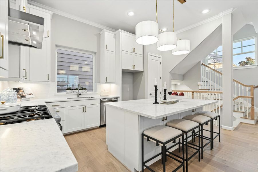 The well-appointed kitchen and island. Equipped with designer lighting and Thermador appliances.