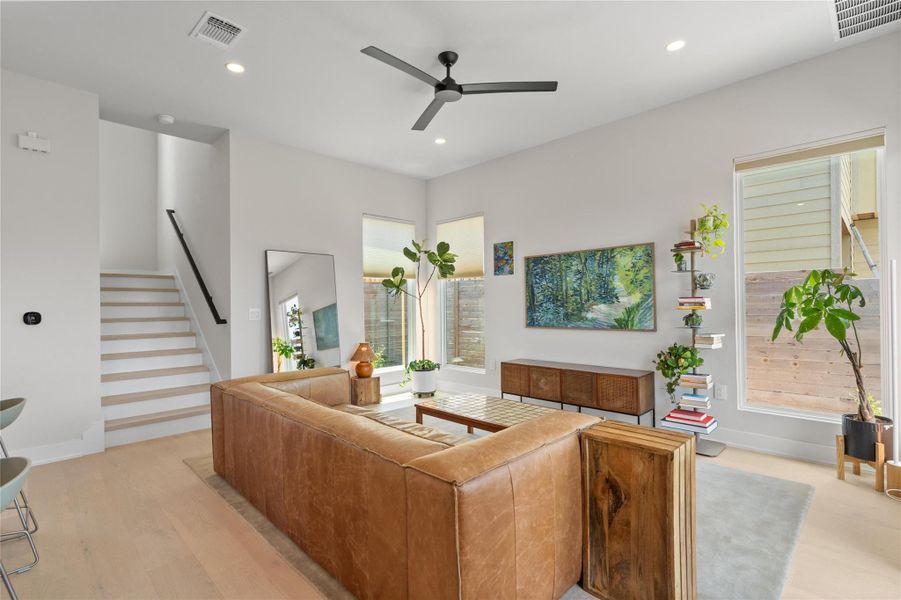 Natural light floods this living area, highlighting high ceilings and polished wood flooring. Natural light floods this living area, highlighting high ceilings and polished wood flooring.