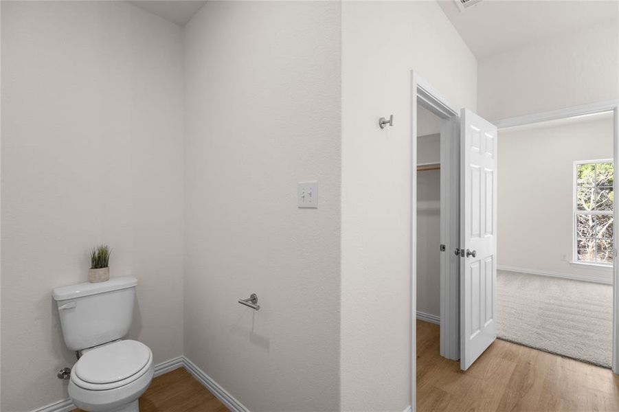 Bathroom with light wood finished floors and baseboards