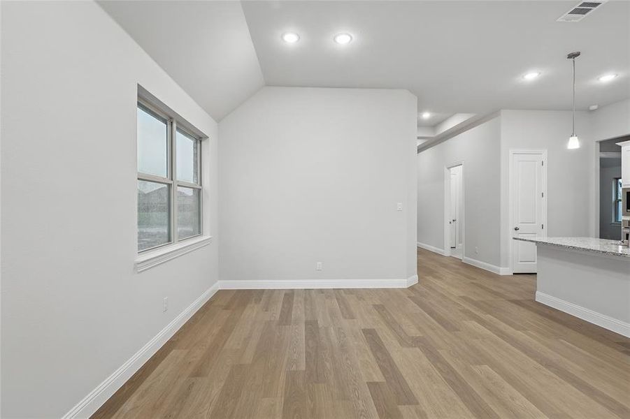 Unfurnished living room with light wood-style floors and recessed lighting Unfurnished living room with light wood-style floors and recessed lighting