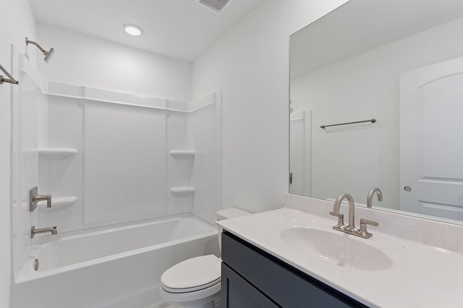A bathroom with a tub sink and toilet. A bathroom with a tub sink and toilet.
