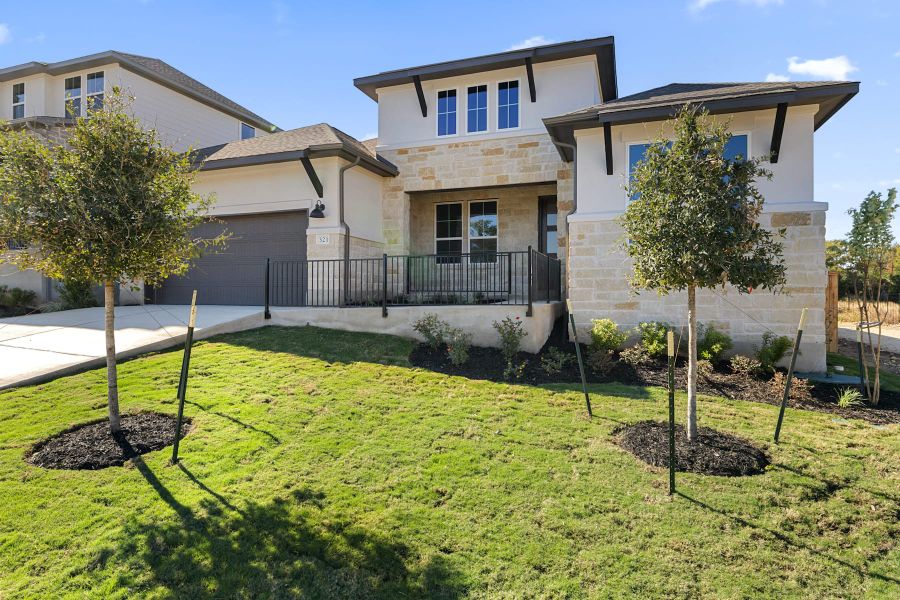 Front exterior of a new home in Lariat, Liberty Hill, TX, highlighting curb appeal (Image 22).
