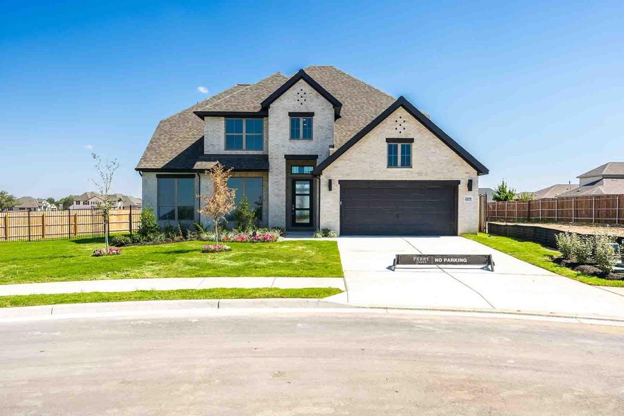 View of front facade featuring concrete driveway, a garage, brick siding, and a shingled roof View of front facade featuring concrete driveway, a garage, brick siding, and a shingled roof