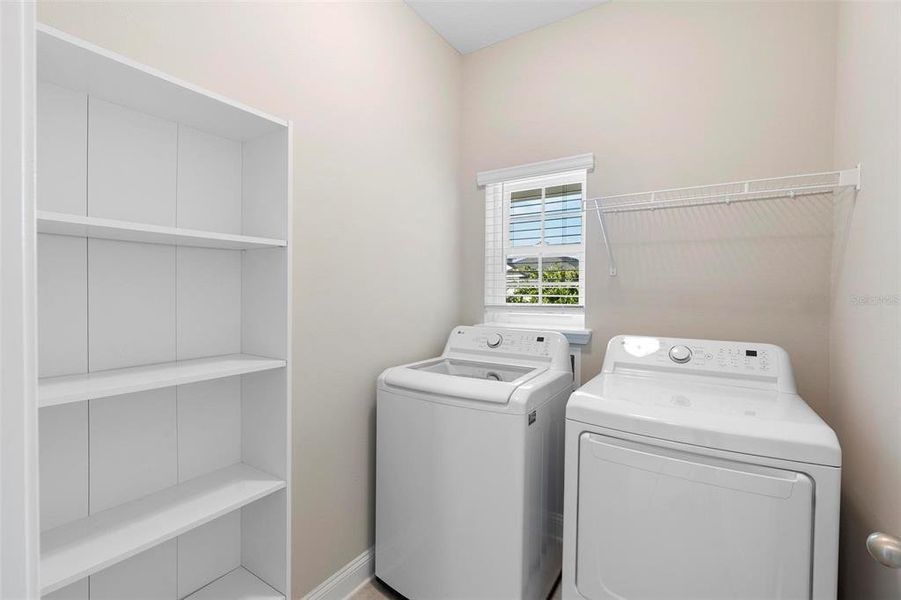 The perfectly sized laundry room adds both practicality and convenience to the property, seamlessly blending into the home's thoughtful design.