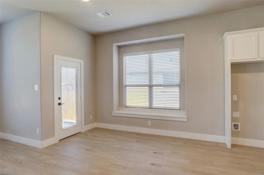 Unfurnished dining area with light wood-type flooring and recessed lighting