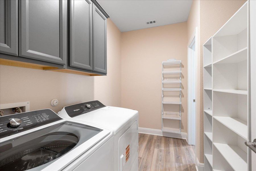 Extra large laundry room has lots of room for storage.