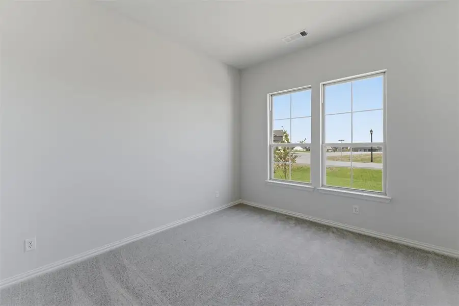 Room featuring light gray carpet, white baseboards, and neutral wall paint