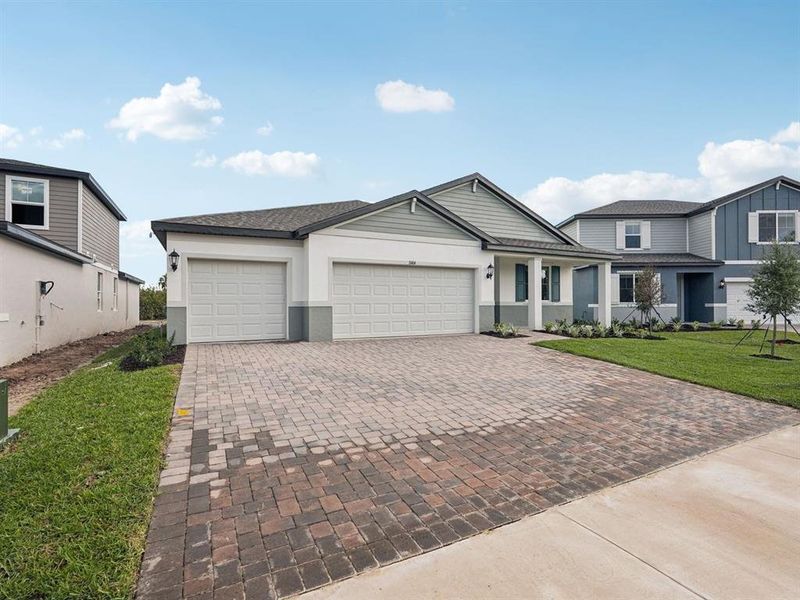 Front exterior of a new home in Oakfield Trails - Signature Series, Parrish, FL, highlighting curb appeal (Image 1). Front exterior of a new home in Oakfield Trails - Signature Series, Parrish, FL, highlighting curb appeal (Image 1).