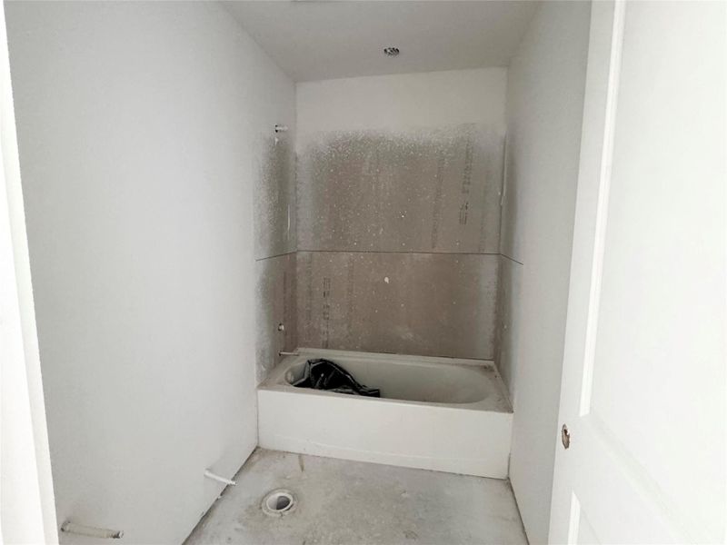 Bathroom with unfinished concrete flooring and shower combination Bathroom with unfinished concrete flooring and shower combination