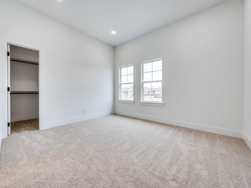 Unfurnished bedroom featuring light carpet