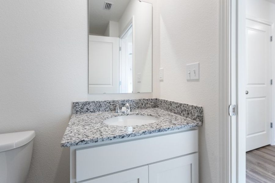 A bathroom with a marble countertop. A bathroom with a marble countertop.