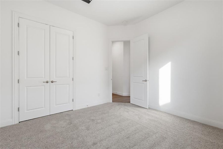 Unfurnished bedroom with carpet floors and a closet
