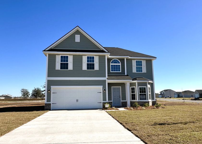Front exterior of a new home in The Village at Sassafras, Allenhurst, GA, highlighting curb appeal (Image 1).