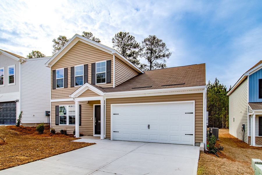 Front exterior of a new home in Ellington, Elgin, SC, highlighting curb appeal (Image 2). Front exterior of a new home in Ellington, Elgin, SC, highlighting curb appeal (Image 2).