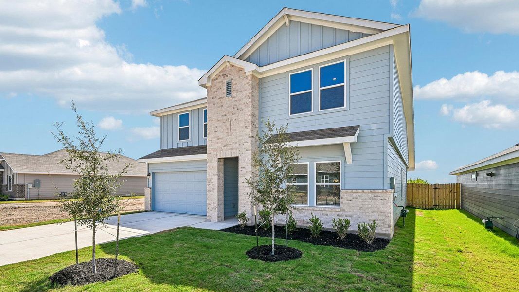 Front exterior of a new home in Carillon, Manor, TX, highlighting curb appeal (Image 21).
