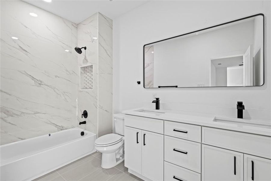 Bathroom with bathtub / shower combination, double vanity, light tile patterned floors, and recessed lighting