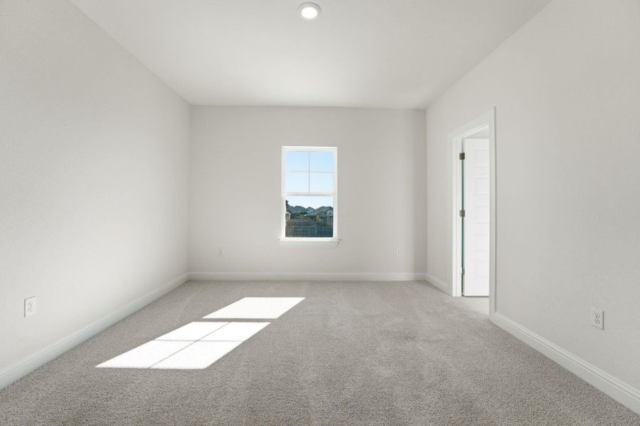 Unfurnished room featuring light colored carpet and baseboards
