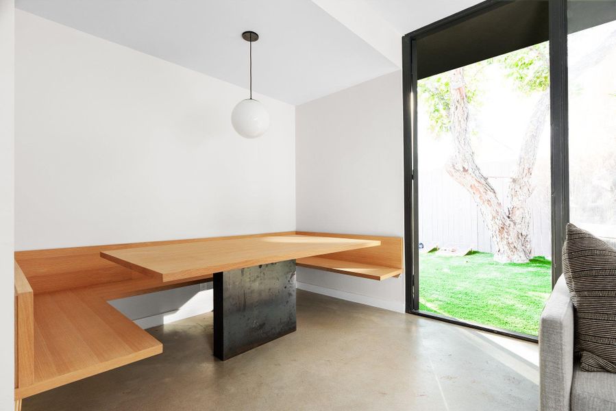 Unfurnished dining area featuring finished concrete flooring and breakfast area Unfurnished dining area featuring finished concrete flooring and breakfast area