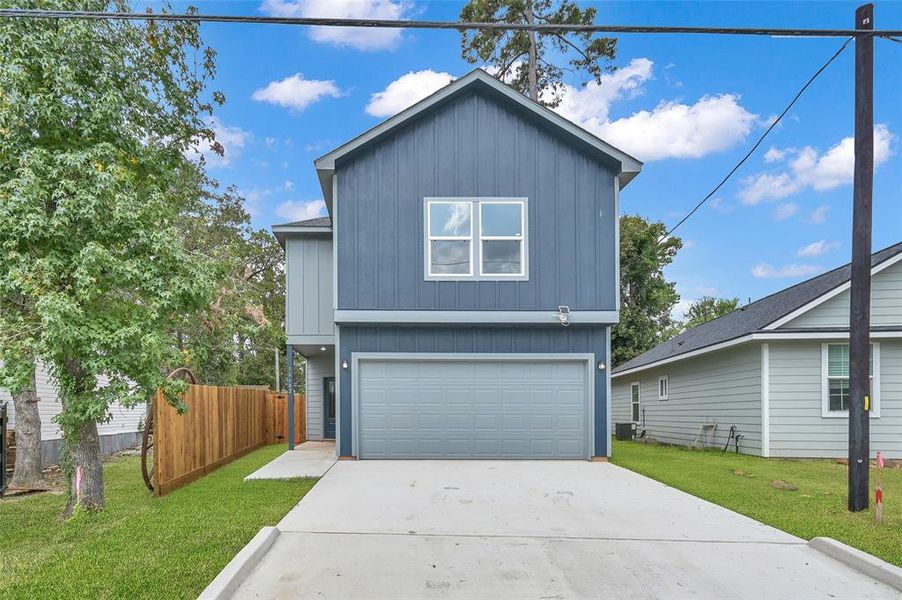 Discover this chic, two-story residence boasting a vibrant blue facade, complete with a spacious attached double garage and a brand-new, private 7-foot wooden fence for your tranquility.