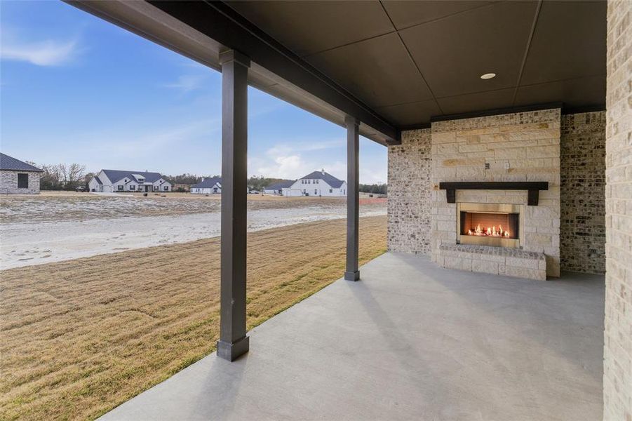 View of patio / terrace with an outdoor stone fireplace and a residential view