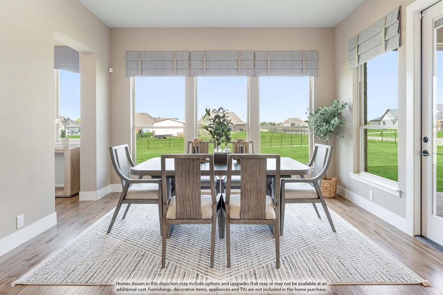 Dining room with wood table, six chairs, hardwood floors, and large windows overlooking a backyard