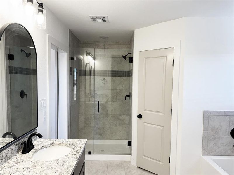 Bathroom with a shower stall, visible vents, marble finish floor, and vanity