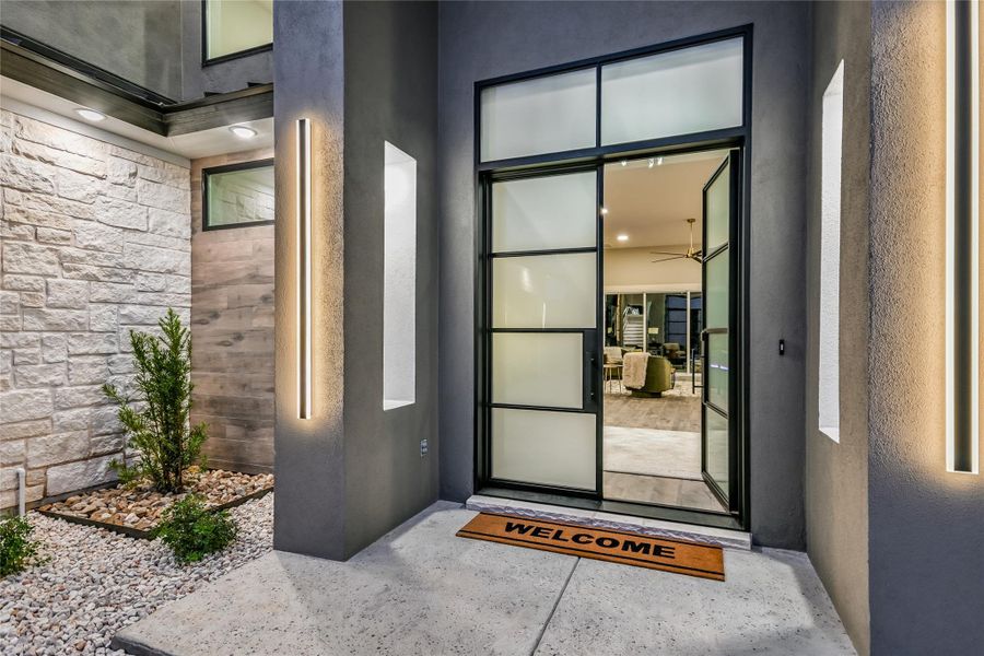 View of exterior entry featuring stone siding and stucco siding View of exterior entry featuring stone siding and stucco siding