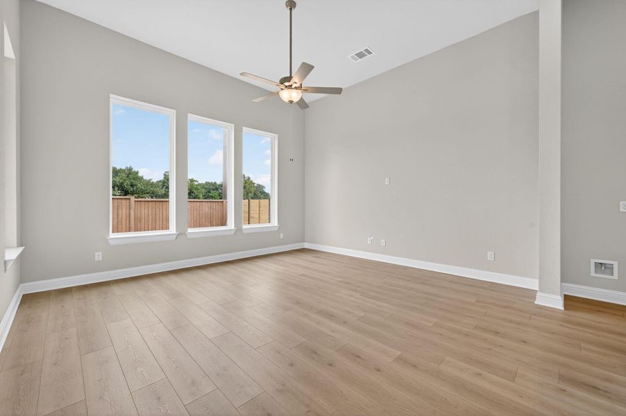Spare room with light wood finished floors and ceiling fan