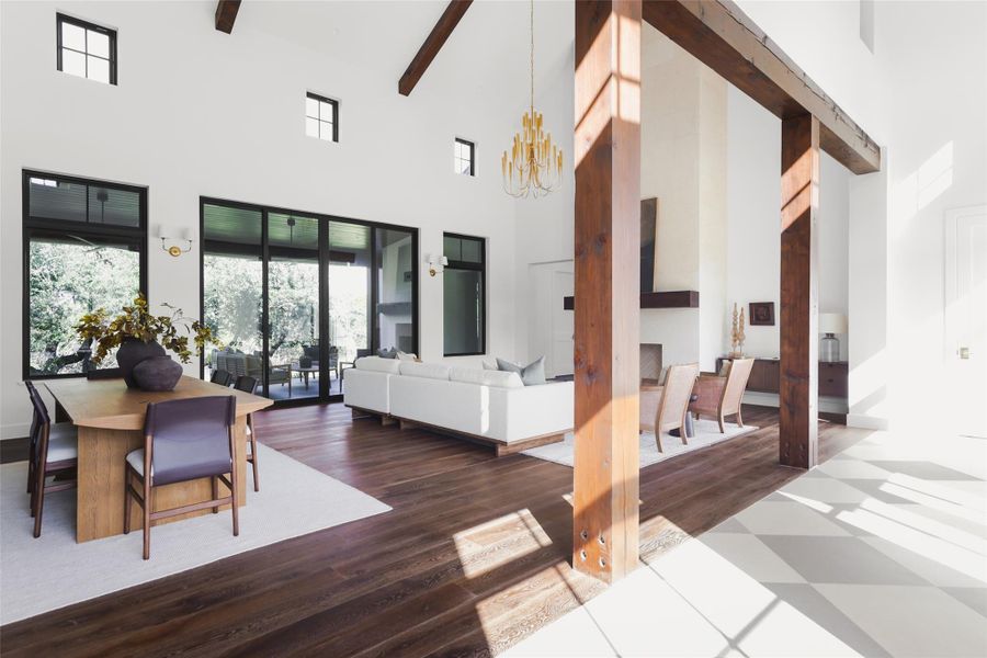 Bringing the Hill Country indoors. Oversized windows in the great room offer a direct view of the private greenbelt and mature trees, flooding the interior with natural light. This design ensures you feel connected to the 1-acre lot even while relaxing inside.