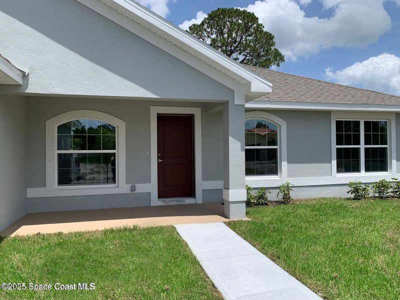 Front exterior of a new home in Palm Bay, Palm Bay, FL, highlighting curb appeal (Image 2).