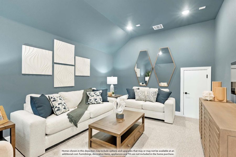 Living room with vaulted ceiling, two white sofas, wood coffee table, and blue-gray walls with decorative mirrors Living room with vaulted ceiling, two white sofas, wood coffee table, and blue-gray walls with decorative mirrors