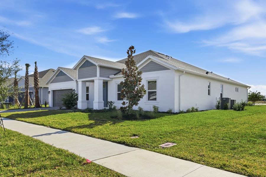 Front exterior of a new home in Ardisia Park, New Smyrna Beach, FL, highlighting curb appeal (Image 2). Front exterior of a new home in Ardisia Park, New Smyrna Beach, FL, highlighting curb appeal (Image 2).