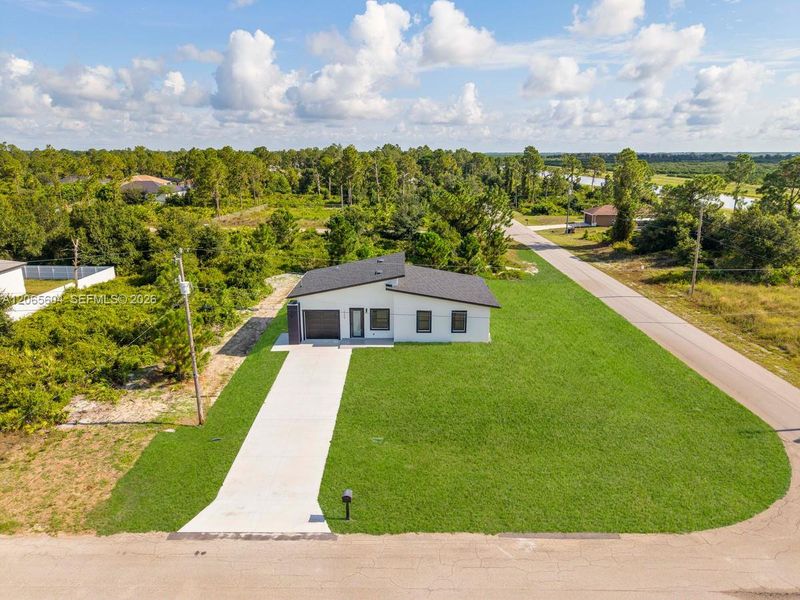 Front exterior of a new home in , Lehigh Acres, FL, highlighting curb appeal (Image 19). Front exterior of a new home in , Lehigh Acres, FL, highlighting curb appeal (Image 19).