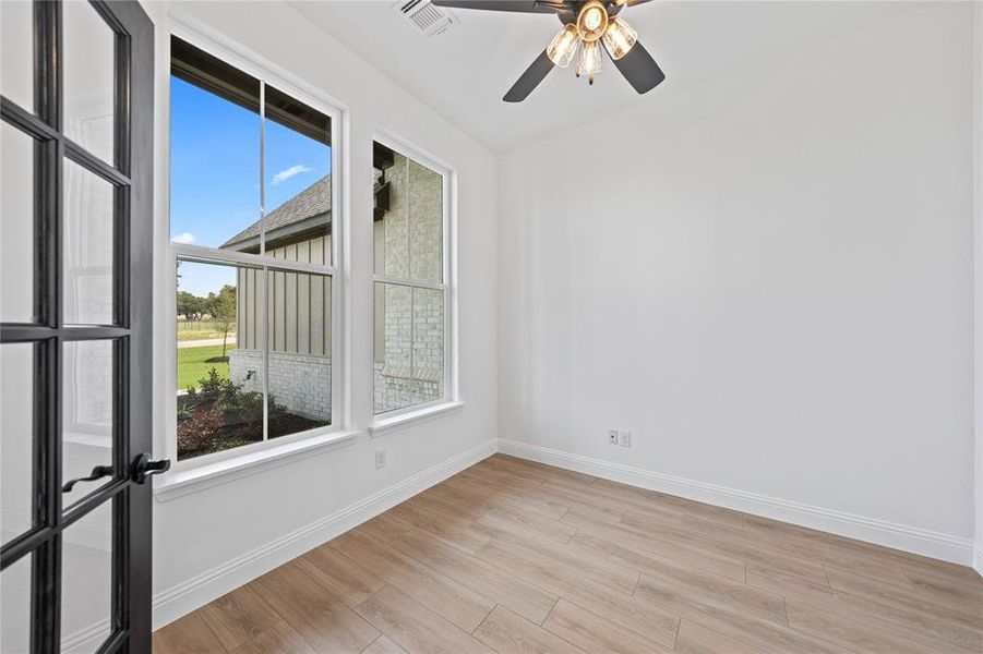 Unfurnished room with light wood-style flooring and ceiling fan