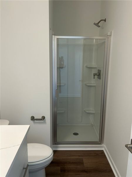 This bathroom features a contemporary shower and r