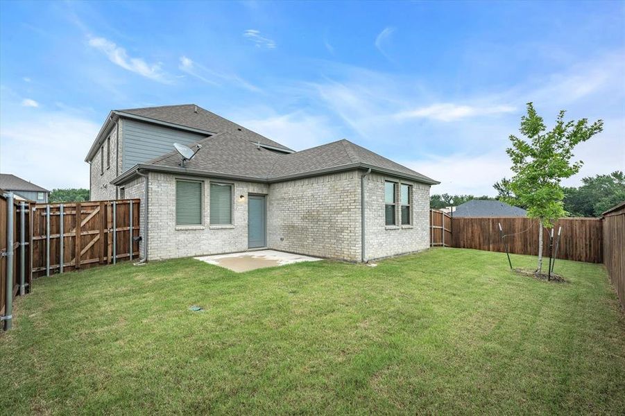 Back of property with a patio area and a lawn