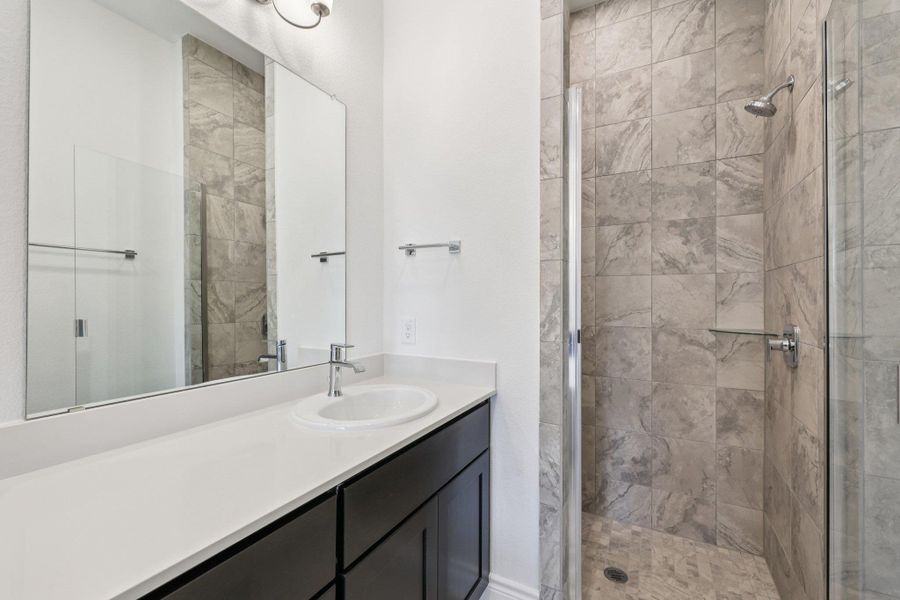 Bathroom with a stall shower and vanity