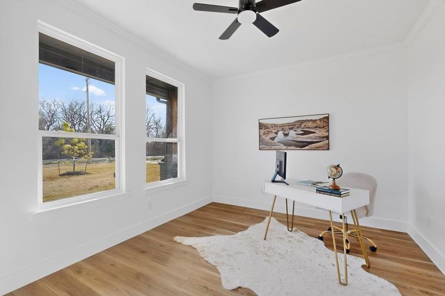 Office area with light wood-type flooring, a ceiling fan, and ornamental molding Office area with light wood-type flooring, a ceiling fan, and ornamental molding