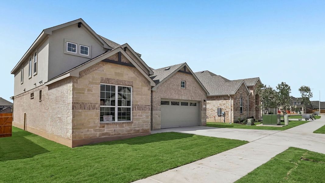 Front exterior of a new home in Rosenbusch Ranch, Leander, TX, highlighting curb appeal (Image 24).