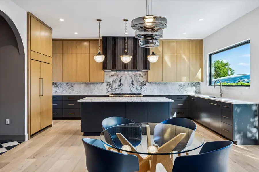 Dining & kitchen featuring modern cabinets, a center island, backsplash Dining & kitchen featuring modern cabinets, a center island, backsplash